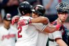 Cleveland Indians' Francisco Lindor, center, hugs Leonys Martin after Lindor hit a two-run home run off Minnesota Twins starting pitcher Devin Smeltzer in the fifth inning of a baseball game, Tuesday, June 4, 2019, in Cleveland. Martin scored on the play. Twins catcher Mitch Garver, right, watches. (AP Photo/Tony Dejak)