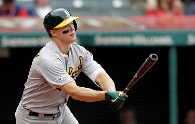 Oakland Athletics' Nick Hundley watches his ball after hitting a one-run double off Cleveland Indians relief pitcher Tyler Clippard in the seventh inning of a baseball game, Wednesday, May 22, 2019, in Cleveland. Ramon Laureano scored on the play. (AP Photo/Tony Dejak)