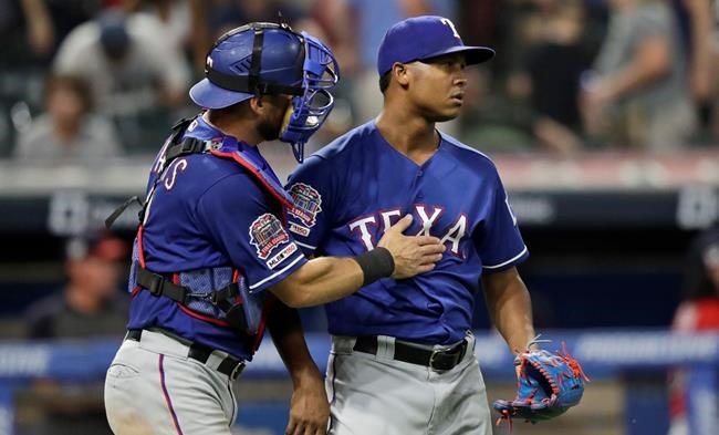 Texas Rangers relief pitcher Jose Leclerc, right, is congratulated by catcher Jeff Mathis after they defeated the Cleveland Indians in a baseball game, Monday, Aug. 5, 2019, in Cleveland. (AP Photo/Tony Dejak)