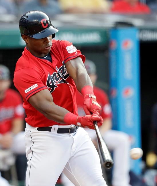 Cleveland Indians' Yasiel Puig hits an RBI single during the first inning of the team's baseball game against the Los Angeles Angels, Friday, Aug. 2, 2019, in Cleveland. (AP Photo/Tony Dejak)