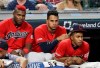 From left to right, Cleveland Indians' Yasiel Puig, Oscar Mercado and Francisco Lindor watch the ninth inning in a baseball game against the Texas Rangers, Monday, Aug. 5, 2019, in Cleveland. (AP Photo/Tony Dejak)