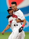 Cleveland Indians' Oscar Mercado, right, celebrates with Francisco Lindor after Mercado hit a game-winning RBI-single off Cincinnati Reds relief pitcher Raisel Iglesias in the tenth inning in a baseball game, Tuesday, June 11, 2019, in Cleveland. Mike Freeman scored on the play. The Indians won 2-1 in ten innings. (AP Photo/Tony Dejak)