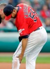 Cleveland Indians starting pitcher Carlos Carrasco holds his knee in the fourth inning of a baseball game against the Miami Marlins, Tuesday, April 23, 2019, in Cleveland. Carrasco, who was coming off a 12-strikeout performance in his previous outing, got hurt when he stumbled and fell while covering first base in the fourth inning Tuesday. He stayed in for two more batters but was pulled after telling manager Terry Francona his leg tightened. (AP Photo/Tony Dejak)