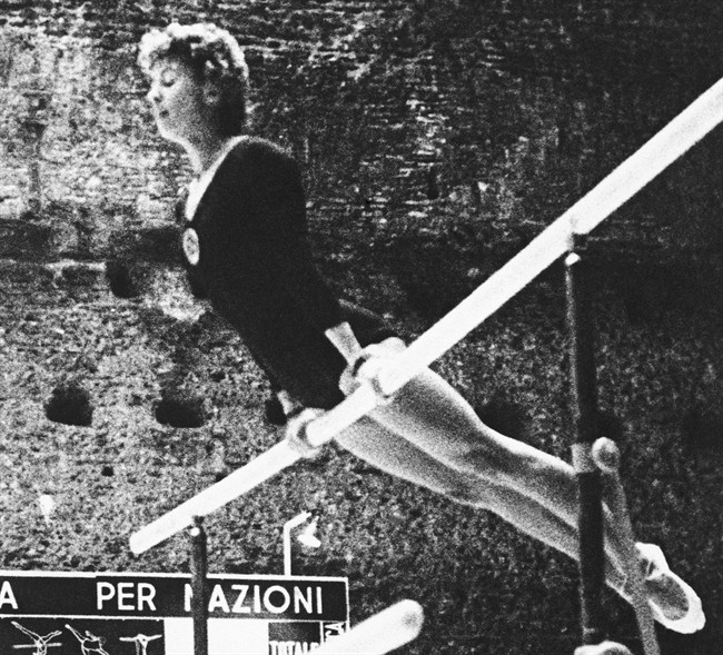 FILE - In this Sept. 8, 1960 file photo, Larisa Latynina of the Soviet Union competes at the 1960 Summer Olympics in Rome. She won the gold medal in the woman's individual gymnastics event. The gymnast whose career record for most Olympic medals was broken by Michael Phelps says she doesn't mind that the American swimmer has surpassed her mark. Latynina, who won 18 medals in the 1956, 1960 and 1964 Olympics, was at the Aquatics Centre in London on Tuesday to watch Phelps, and she says she was happy for him. (AP Photo)