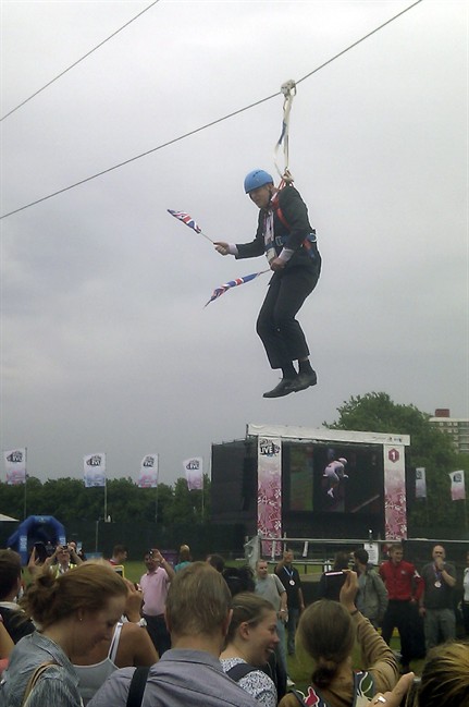This mobile phone photo provided by Lee Medcalf shows Boris Johnson, the mayor of London, dangling in midair above the crowds at an open-air viewing site at east London’s Victoria Park, on Wednesday, Aug. 1, 2012. (AP Photo/Lee Medcalf)