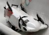 The team from Canada CAN-3, with Justin Kripps, Jesse Lumsden, Cody Sorensen and Ben Coakwell, slide down the track upside down after crashing in turn sixteen during the men's four-man bobsled competition at the 2014 Winter Olympics, Saturday, Feb. 22, 2014, in Krasnaya Polyana, Russia. (AP Photo/Dita Alangkara)