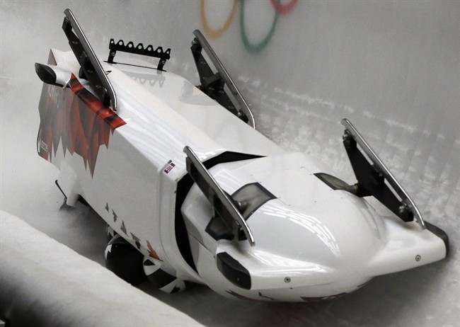 The team from Canada CAN-3, with Justin Kripps, Jesse Lumsden, Cody Sorensen and Ben Coakwell, slide down the track upside down after crashing in turn sixteen during the men's four-man bobsled competition at the 2014 Winter Olympics, Saturday, Feb. 22, 2014, in Krasnaya Polyana, Russia. (AP Photo/Dita Alangkara)