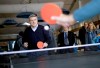 International Olympic Committee President Thomas Bach plays ping pong with IOC staff while touring the Coastal Cluster athlete's village at the 2014 Winter Olympics, Tuesday, Feb. 4, 2014, in Sochi, Russia. (AP Photo/David Goldman)