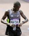 Gour Marial, who is stateless, checks his time after finishing the men's marathon at the 2012 Summer Olympics, Sunday, Aug. 12, 2012, in London. Marial, from South Sudan, competed in the marathon under the Olympic flag. (AP Photo/Mike Groll)