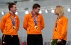 Speedskater from the Netherlands Sven Kramer, center, speaks with teammate Koen Verweij, as Jan Blokhuijsen laughs during the medal ceremony for the men's team pursuit at the Adler Arena Skating Center at the 2014 Winter Olympics, Saturday, Feb. 22, 2014, in Sochi, Russia. Netherlands won the gold. (AP Photo/Matt Dunham)