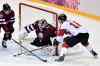 NATHAN DENETTE / THE CANADIAN PRESS
Latvian goaltender Kristers Gudlevskis stymies centre Jonathan Toews on one of 57 Canadian shots on Wednesday night. Team Canada eked out a narrow 2-1 triumph.