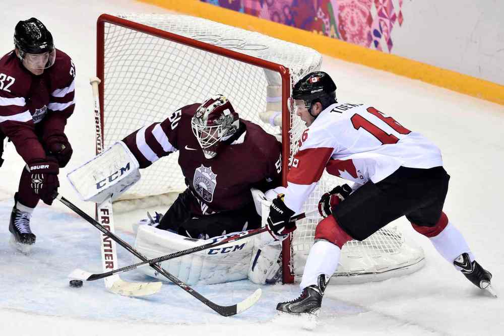 NATHAN DENETTE / THE CANADIAN PRESS
Latvian goaltender Kristers Gudlevskis stymies centre Jonathan Toews on one of 57 Canadian shots on Wednesday night. Team Canada eked out a narrow 2-1 triumph.