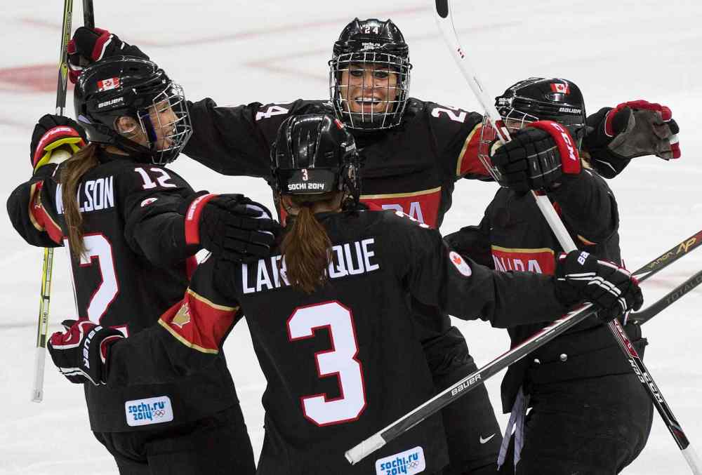 Nathan Denette / The Canadian Press
Canada defenceman Jocelyne Larocque (3) celebrates her goal with Canada forward Natalie Spooner, centre, and teammates while playing against Switzerland during first period women's Olympic hockey action at the 2014 Sochi Winter Olympics in Sochi, Russia on Saturday.