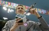 United States' swimmer Michael Phelps holds up a silver trophy after being honored as the most decorated Olympian at the Aquatics Centre in the Olympic Park during the 2012 Summer Olympics in London, Saturday, Aug. 4, 2012.(AP Photo/Matt Slocum)