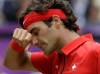 Roger Federer of Switzerland wipes his face during his match against Juan Martin del Potro of Argentina at the All England Lawn Tennis Club in Wimbledon, London at the 2012 Summer Olympics, Friday, Aug. 3, 2012. (AP Photo/Elise Amendola)