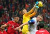 Turkey's goalkeeper Mert Gunok, center, hits the ball by his teammate Merih Demiral, left, and Iceland's Kolbeinn Sigthorsson, right, during the Euro 2020 Group H qualifying soccer match between Turkey and Iceland in Istanbul, Thursday, Nov. 14, 2019. (AP Photo)