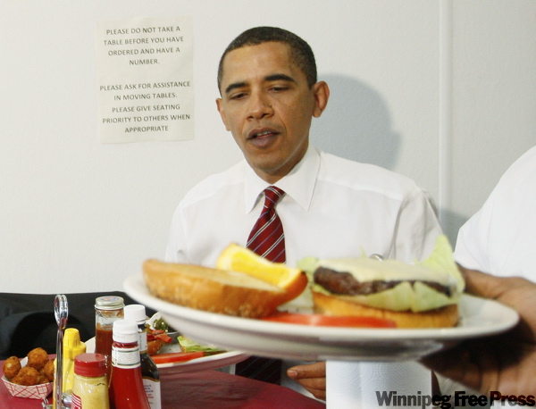 CHARLES DHARAPAK / THE ASSOCIATED PRESS
Barack Obama is served his cheeseburger with — gasp — Dijon mustard at Ray’s Hell Burger in Arlington, Va.