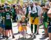 Mike Roemer / Associated Press files
Ricky Collins walks back to Lambeau Field with a little girl on her bike after Green Bay's football training camp last year. He was released last summer from the Packers.