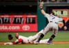 Philadelphia Phillies' Jean Segura, left, gets caught stealing with the tag by Colorado Rockies second baseman Brendan Rodgers, right, during the first inning of a baseball game Friday, May 17, 2019, in Philadelphia. (AP Photo/Chris Szagola)