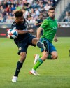 Philadelphia Union's Auston Trusty, left, kicks the ball away from Seattle Sounders' Will Bruin during the first half of an MLS soccer match Saturday, May 18, 2019, in Chester, Pa. (AP Photo/Chris Szagola)