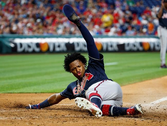 Atlanta Braves' Ronald Acuna Jr. slides to score a run on the hit by Ozzie Albies during the fifth inning of a baseball game against the Philadelphia Phillies, Friday, July 26, 2019, in Philadelphia. (AP Photo/Chris Szagola)