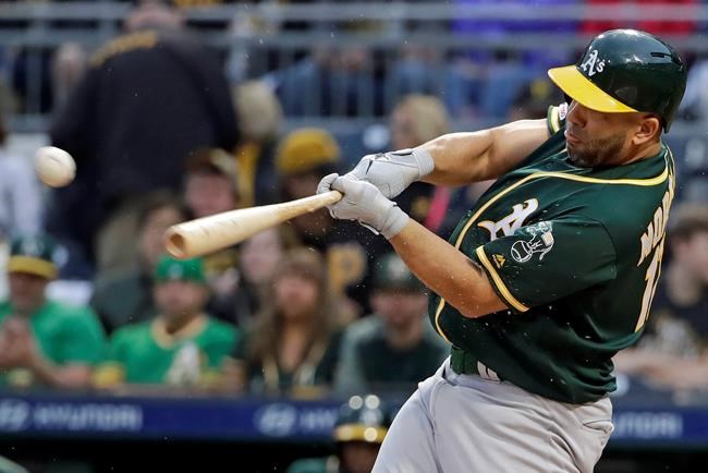 Oakland Athletics' Kendrys Morales drives in a run with a triple off Pittsburgh Pirates starting pitcher Trevor Williams during the first inning of a baseball game in Pittsburgh, Saturday, May 4, 2019. (AP Photo/Gene J. Puskar)