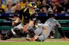 Pittsburgh Pirates catcher Francisco Cervelli, left, can't get the tag on Arizona Diamondbacks' Jarrod Dyson who scores from third on a fielder's choice by David Peralta in the sixth inning of a baseball game in Pittsburgh, Tuesday, April 23, 2019. (AP Photo/Gene J. Puskar)