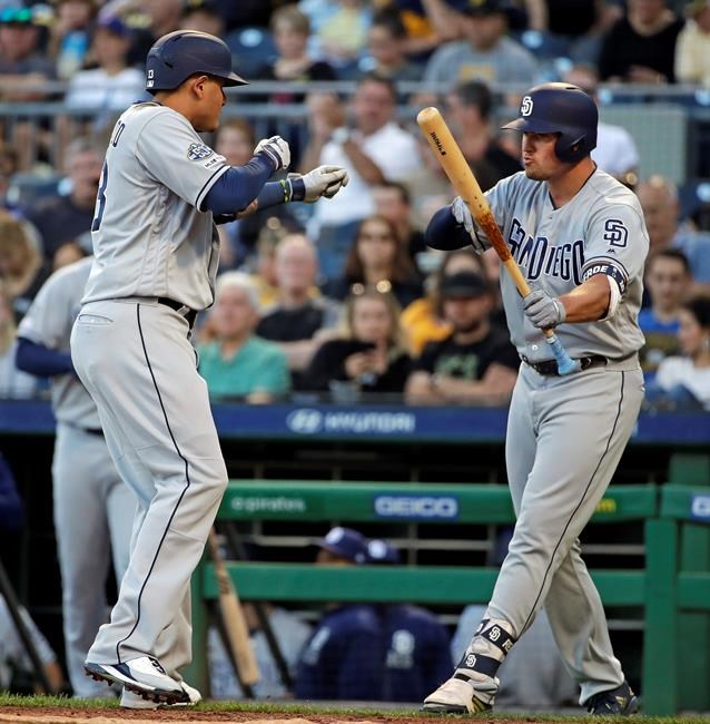 San Diego Padres' Manny Machado, left, celebrates with Hunter Renfroe as he heads to the dugout after hitting a solo home run off Pittsburgh Pirates starting pitcher Joe Musgrove during the fourth inning of a baseball game in Pittsburgh, Friday, June 21, 2019. (AP Photo/Gene J. Puskar)