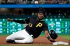 Pittsburgh Pirates' Josh Bell slides into third as a throw from Los Angeles Dodgers catcher Russell Martin gets past third baseman Max Muncy, allowing Bell to score, during the second inning of a baseball game in Pittsburgh, Saturday, May 25, 2019. (AP Photo/Gene J. Puskar)