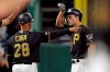 Pittsburgh Pirates' Adam Frazier, right, stands on third base next to coach Joey Cora and gestures to the dugout after driving in two runs with a triple off St. Louis Cardinals relief pitcher John Brebbia during the seventh inning of a baseball game in Pittsburgh, Friday, Sept. 6, 2019. (AP Photo/Gene J. Puskar)