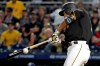 Pittsburgh Pirates' Jung Ho Kang hits a ground ball down the third baseline that San Diego Padres third baseman Manny Machado bobbled and forced an errant throw to first that allowed Kang to advance to second during the seventh inning of a baseball game in Pittsburgh, Friday, June 21, 2019. (AP Photo/Gene J. Puskar)