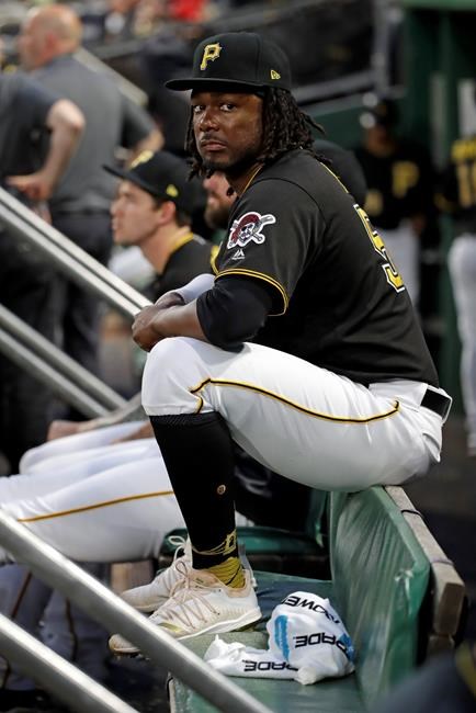 Pittsburgh Pirates' Josh Bell sits in the dugout during the fifth inning of the team's baseball game against the Milwaukee Brewers in Pittsburgh, Wednesday, Aug. 7, 2019. (AP Photo/Gene J. Puskar)
