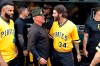 Pittsburgh Pirates pitching coach Ray Searage, left center, and starting pitcher Trevor Williams (34) share a moment together after the final baseball game of the Pirates season, a 3-1 loss to the Cincinnati Reds, in Pittsburgh, Sunday, Sept. 29, 2019. (AP Photo/Gene J. Puskar)