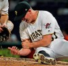 Pittsburgh Pirates relief pitcher Nick Burdi holds his right arm after delivering a pitch during the eighth inning of a baseball game against the Arizona Diamondbacks in Pittsburgh, Monday, April 22, 2019. Burdi left the game with a team trainer. The Diamondbacks won 12-4. (AP Photo/Gene J. Puskar)