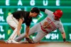 Cincinnati Reds' Kyle Farmer (52) steals second ahead of the tag by Pittsburgh Pirates shortstop Kevin Newman in the eighth inning of a baseball game, Saturday, Sept. 28, 2019, in Pittsburgh. (AP Photo/Keith Srakocic)
