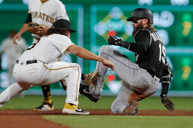 Colorado Rockies' Charlie Blackmon, righty, is tagged out by Pittsburgh Pirates shortstop Cole Tucker on a steal attempt during the seventh inning of a baseball game Tuesday, May 21, 2019, in Pittsburgh. The Rockies won 5-0. (AP Photo/Keith Srakocic)