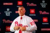 Philadelphia Phillies new manager Joe Girardi puts on his uniform during a news conference in Philadelphia, Monday, Oct. 28, 2019. The Phillies hired Girardi, the former New York Yankees manager, to replace Gabe Kapler. (AP Photo/Matt Rourke)