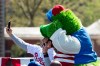 Philadelphia Phillies' Bryce Harper makes a selfie with the team mascot, the Phillie Phanatic, during a Major League Baseball news conference, Tuesday, April 16, 2019, on Independence Mall in Philadelphia. Baseball's 2026 All-Star Game will be played in Philadelphia to mark the 250th anniversary of the Declaration of Independence. (AP Photo/Matt Rourke)