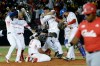 Panama's Los Toros de Herrera baseball players celebrate their 3-0 victory over Cuba's Los Leneros de las Tunas at the end of the Caribbean Series baseball tournament's final, championship game at Rod Carew stadium in Panama City, Sunday, Feb. 10, 2019. (AP Photo/Arnulfo Franco)