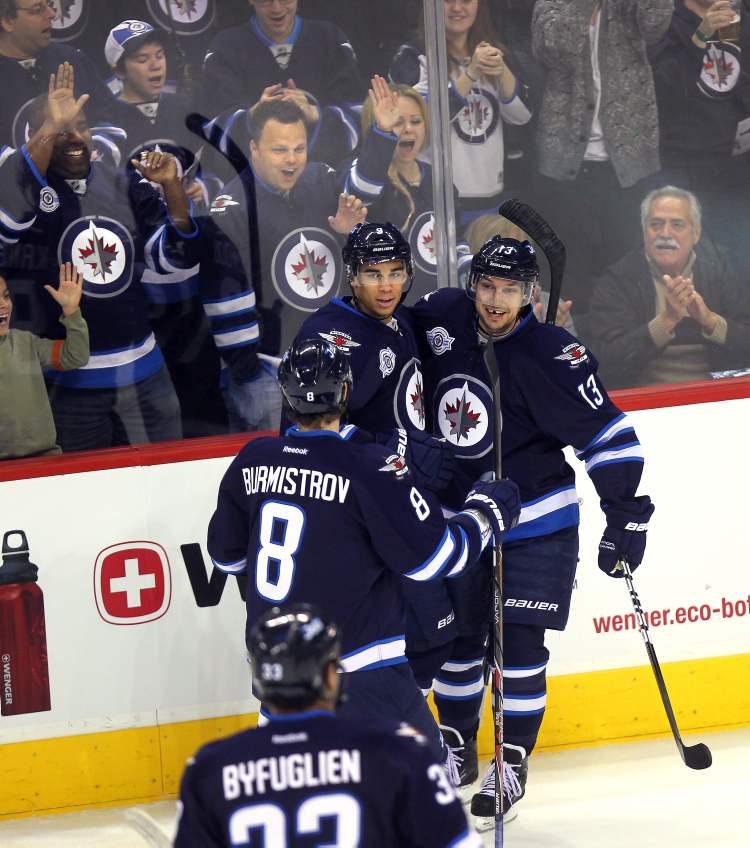 Phil Hossack / Winnipeg Free Press
Winnipeg Jets' Evander Kane celebrates with Kyle Wellwood, Alexander Burmistrov, and Dustin Byfuglien after scoring his 25th goal (this one unassisted) to open scoring at the MTS Centre on Thursday.