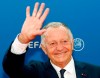 FILE - In this Aug.30, 2018 file photo, President of Lyon soccer club Jean-Michel Aulas arrives for the UEFA Champions League draw at the Grimaldi Forum, in Monaco. Despite a season marred by many ups and downs and the hostility of many fans, the Lyon coach Bruno Genesio had reportedly reached a deal with president Jean-Michel Aulas for a two-year contract extension. (AP Photo/Claude Paris, File)