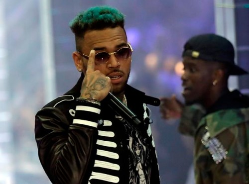 FILE - In this Sept.21, 2018 file photo, singer Chris Brown performs during Philipp Plein's women's 2019 Spring-Summer collection, unveiled during the Fashion Week in Milan, Italy. Two police officials say U.S. singer Chris Brown and two other people are in custody in Paris after a woman filed a rape complaint. (AP Photo/Luca Bruno, File)