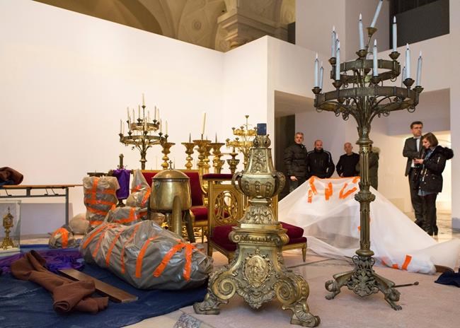 This photo provided Wednesday April 17, 2019 by the Paris City Hall shows artifacts rescued from the Notre Dame blaze, Tuesday April 16, 2019 in Paris. French President Emmanuel Macron ratcheted up the pressure by setting a five-year deadline to restore the 12th-century landmark. Macron is holding a special Cabinet meeting Wednesday dedicated to the Notre Dame disaster, which investigators believe was an accident possibly linked to renovation work. (Henri Garat/Ville de Paris via AP)