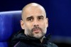 Manchester City coach Pep Guardiola takes his seat prior to the first leg, round of sixteen, Champions League soccer match between Schalke 04 and Manchester City at Veltins Arena in Gelsenkirchen, Germany, Wednesday Feb. 20, 2019. (AP Photo/Michael Probst)