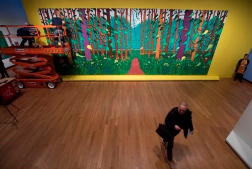Employees of the Van Gogh Museum make last adjustments when mounting the 32-canvas painting by David Hockney titled 