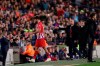 Atletico forward Diego Costa passes his coach Diego Simeone, right, as walks off the pitch after receiving a red card for insulting referee Jesus Gil Manzano during a Spanish La Liga soccer match between FC Barcelona and Atletico Madrid at the Camp Nou stadium in Barcelona, Spain, Saturday April 6, 2019. (AP Photo/Manu Fernandez)