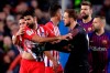 Atletico goalkeeper Jan Oblak, center right, tries to calm down teammate Diego Costa, left, after he was sent off with a red card for insulting referee Jesus Gil Manzano during a Spanish La Liga soccer match between FC Barcelona and Atletico Madrid at the Camp Nou stadium in Barcelona, Spain, Saturday April 6, 2019. (AP Photo/Manu Fernandez)