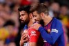 Barcelona's Gerald Pique, right, talks to Atletico forward Diego Costa who was sent off with a red card for insulting referee Jesus Gil Manzano during a Spanish La Liga soccer match between FC Barcelona and Atletico Madrid at the Camp Nou stadium in Barcelona, Spain, Saturday April 6, 2019. (AP Photo/Manu Fernandez)