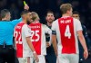 This Wednesday Feb. 13, 2019, image shows referee Damir Skomina, left, showing a yellow card to Real's Sergio Ramos, center, after a foul on Ajax's Kasper Dolberg during the first leg, round of sixteen, Champions League soccer match between Ajax and Real Madrid at the Johan Cruyff ArenA in Amsterdam, Netherlands. UEFA is investigating reported comments by Real Madrid captain Sergio Ramos that he intentionally got a yellow card to provoke a favorable Champions League ban. (AP Photo/Peter Dejong)