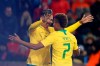 Brazil's Roberto Firmino, left, and Brazil's David Neres celebrate after their team scored their side's second goal during the international friendly soccer match between the Czech Republic and Brazil at the Sinobo stadium in Prague, Czech Republic, Tuesday, March 26, 2019. (AP Photo/Petr David Josek)